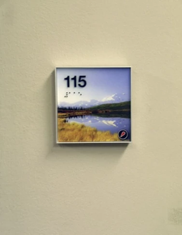 Digital print inserted into a wall frame with ADA numbers