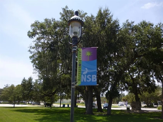 Custom banner install on city park light pole